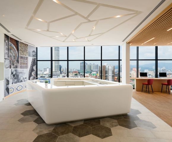 Spacious hotel room featuring large windows, modern decor, and a cozy seating area.