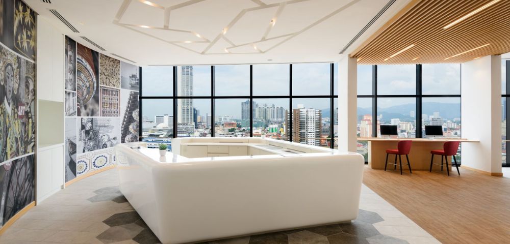 Spacious hotel room featuring large windows, modern decor, and a cozy seating area.