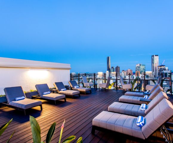 Outdoor lounge terrace with seating arrangements overlooking the sea or ocean.