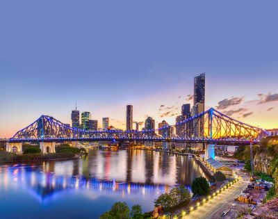 Another angle of the illuminated bridge, highlighting the city skyline in the background.