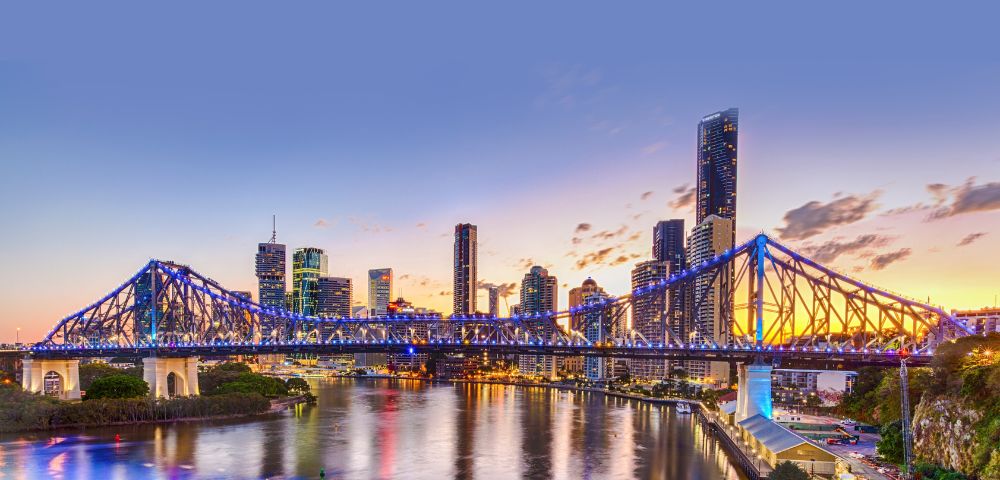 Another angle of the illuminated bridge, highlighting the city skyline in the background.