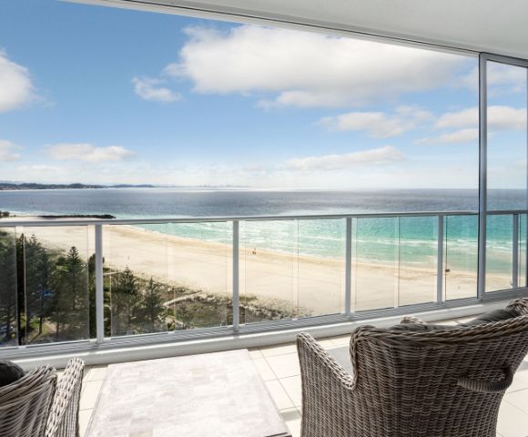 Alternate balcony view showing an expansive ocean scene with outdoor seating.