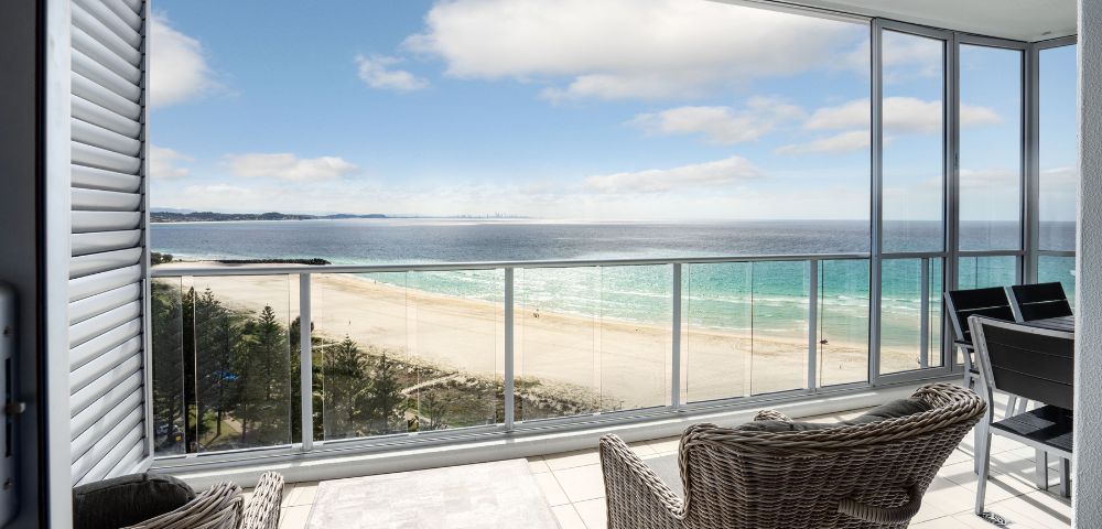 Alternate balcony view showing an expansive ocean scene with outdoor seating.