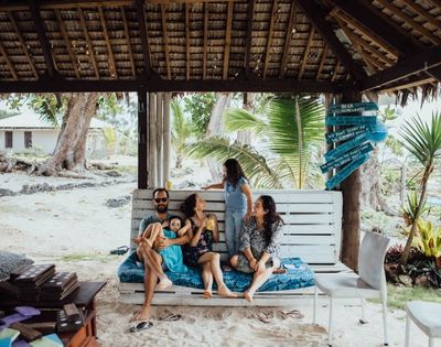 Family playing outdoors in a natural setting.