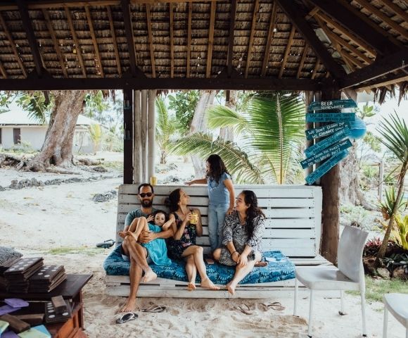 Family playing outdoors in a natural setting.
