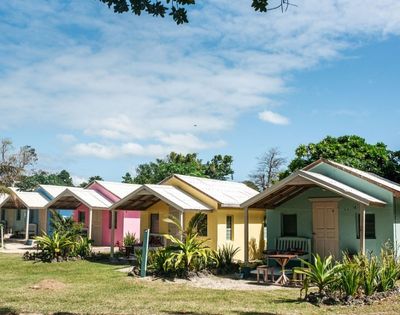 Colorful houses lined up neatly against a clear blue sky.