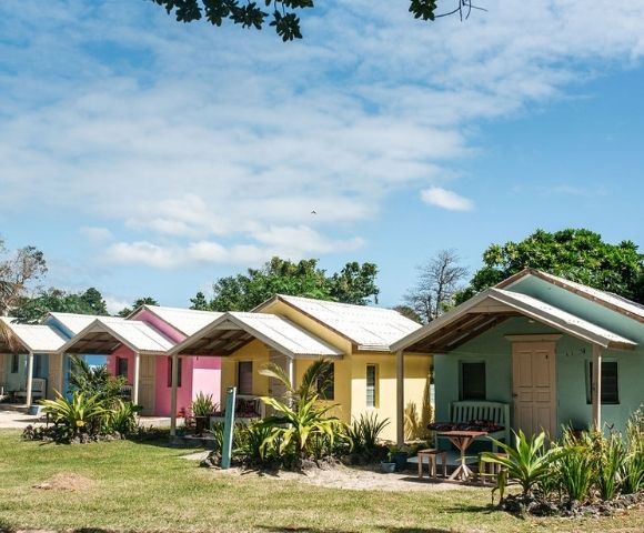 Colorful houses lined up neatly against a clear blue sky.