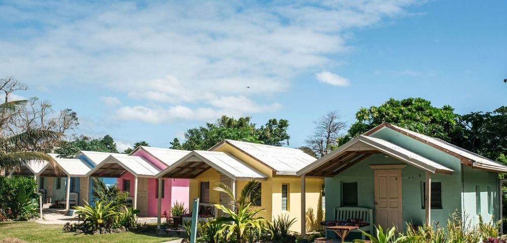 Colorful houses lined up neatly against a clear blue sky.