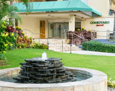 Hotel building surrounded by tropical greenery.