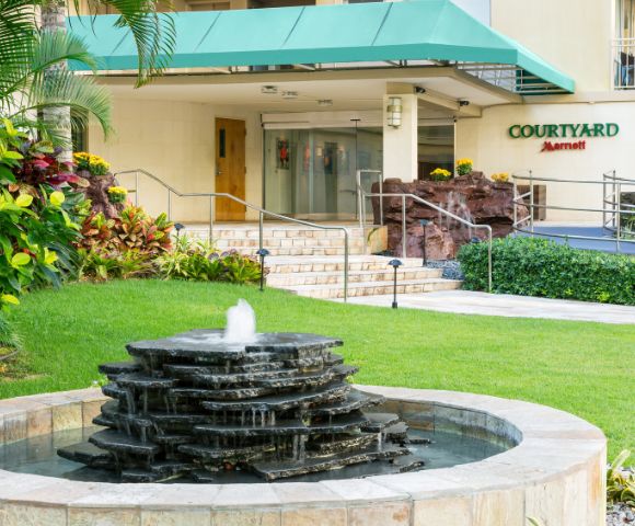 Hotel building surrounded by tropical greenery.