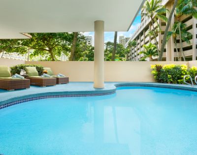 Alternate view of the swimming pool area with surrounding greenery.