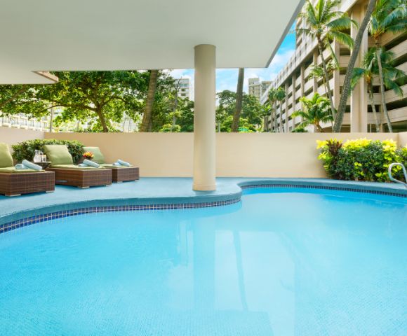 Alternate view of the swimming pool area with surrounding greenery.