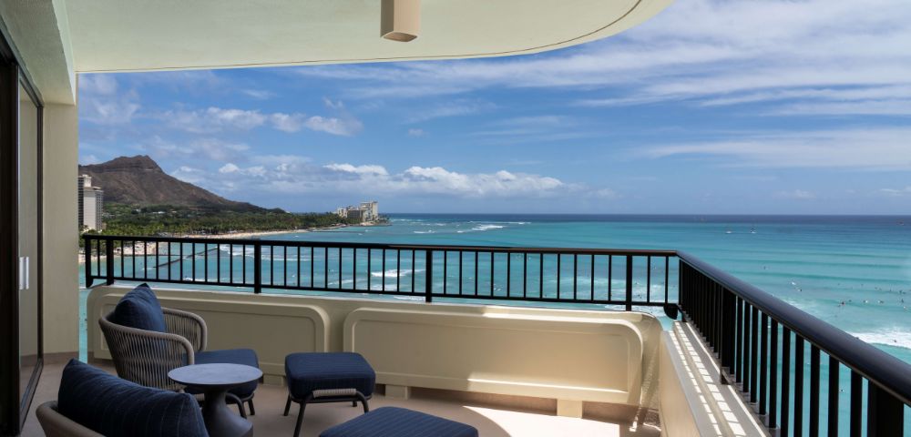 Balcony with seating overlooking the ocean and Diamond Head in the distance, showcasing scenic views from the Moana Surfrider.
