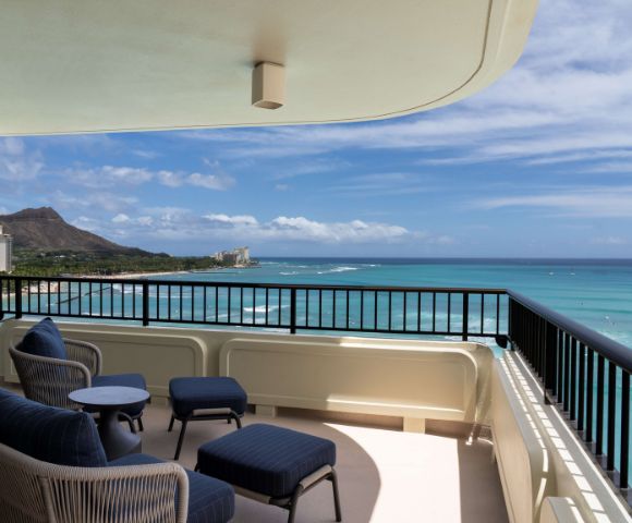 Balcony with seating overlooking the ocean and Diamond Head in the distance, showcasing scenic views from the Moana Surfrider.