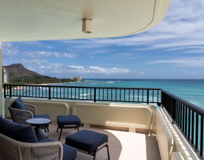 Balcony with seating overlooking the ocean and Diamond Head in the distance, showcasing scenic views from the Moana Surfrider.