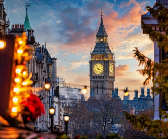 Christmas market stall in Edinburgh bustling with people shopping and enjoying the festive atmosphere.