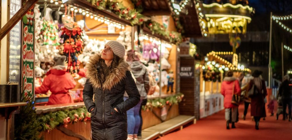 Big Ben at sunset with festive holiday lights and decorations in the foreground in London.