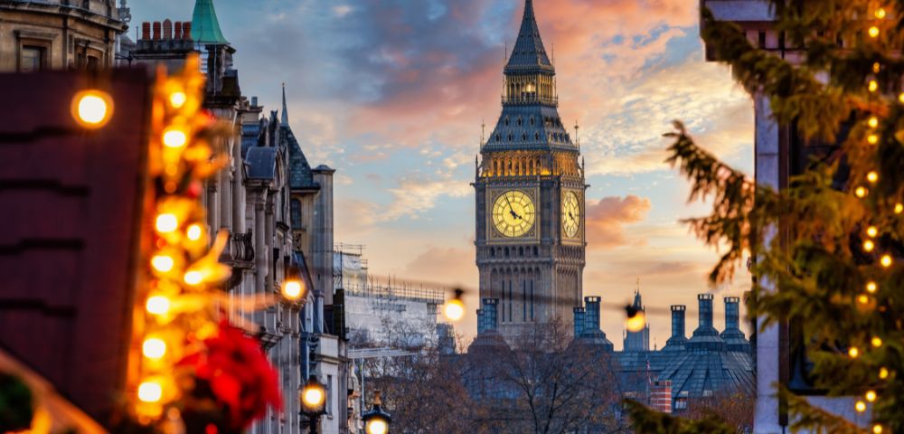 Christmas market stall in Edinburgh bustling with people shopping and enjoying the festive atmosphere.