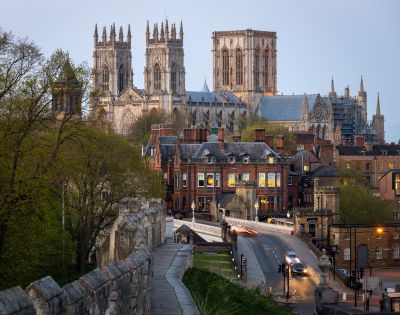 A scenic view of York Minster in England, showcasing its towering Gothic architecture above the historic city buildings.