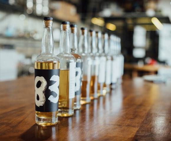 Several bottles of liquor displayed on a wooden surface, sourced from an online search result.