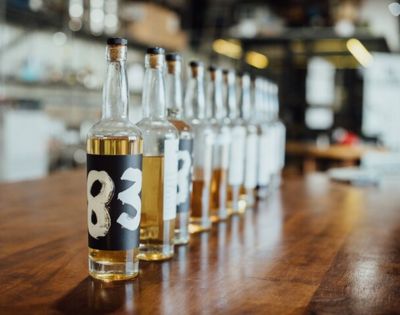 Several bottles of liquor displayed on a wooden surface, sourced from an online search result.