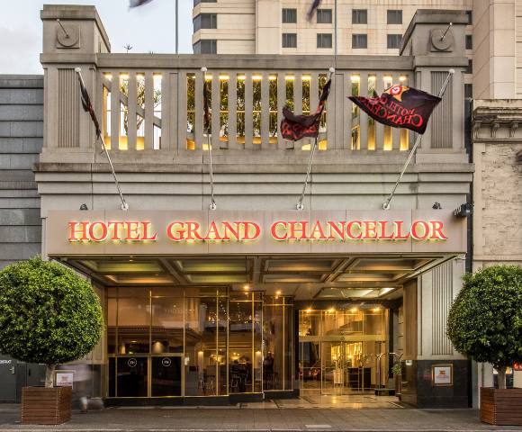 Elegant street-facing exterior of Hotel Grand Chancellor Adelaide with large windows and decorative architectural elements.