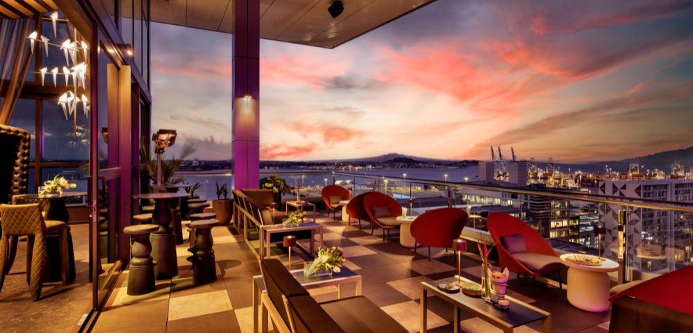 Rooftop bar or restaurant with outdoor seating and sunset views.