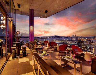 Rooftop bar or restaurant with outdoor seating and sunset views.
