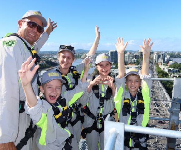 Group photo with everyone raising their hands in excitement overlooking the city.