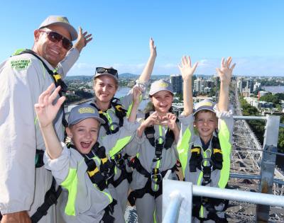Group photo with everyone raising their hands in excitement overlooking the city.