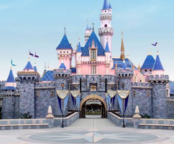 Brightly lit Disneyland castle in Anaheim, serving as a central attraction in the park.