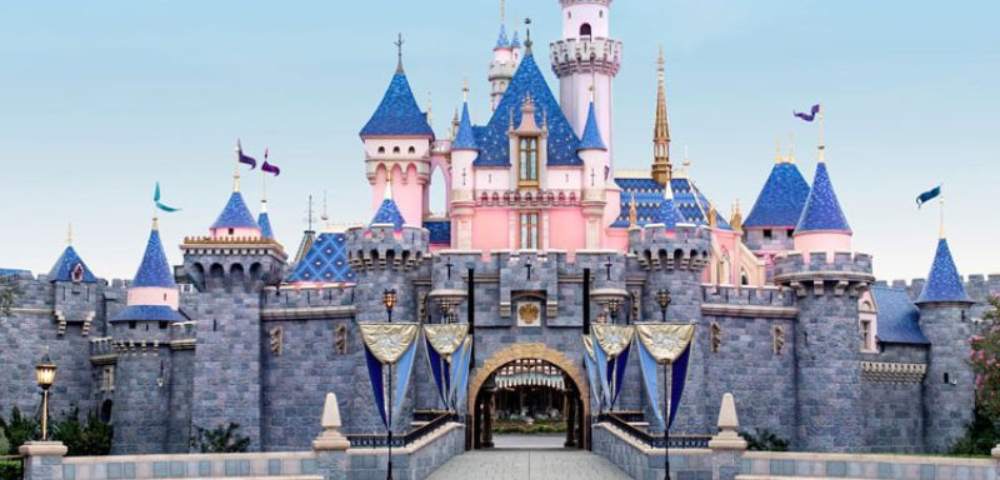 Brightly lit Disneyland castle in Anaheim, serving as a central attraction in the park.