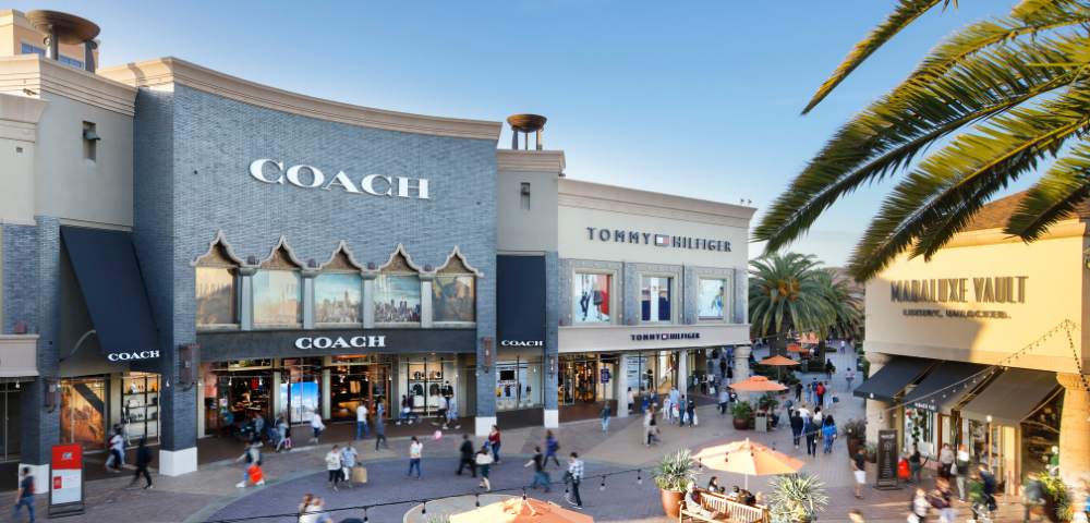 Another exterior view of Citadel Outlets showing stores and people shopping.