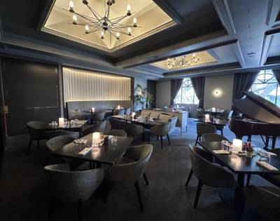 Sophisticated dining room with chandeliers, intimate seating, and elegant decor.