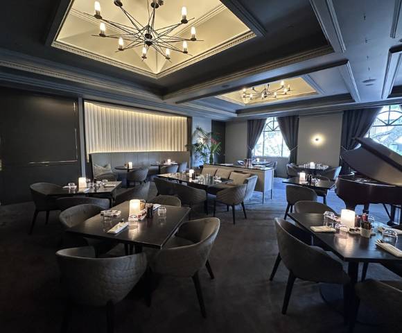 Sophisticated dining room with chandeliers, intimate seating, and elegant decor.