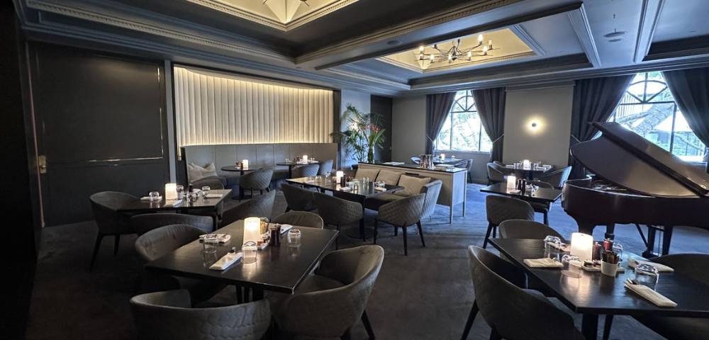 Sophisticated dining room with chandeliers, intimate seating, and elegant decor.