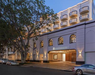 Exterior view of a building illuminated by warm lights during dusk