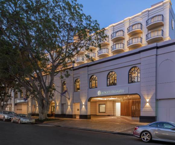 Exterior view of a building illuminated by warm lights during dusk