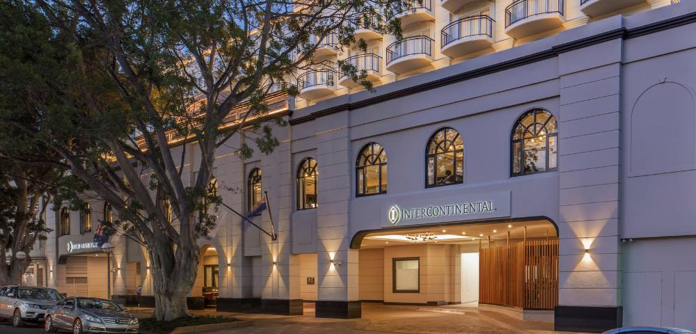 Exterior view of a building illuminated by warm lights during dusk