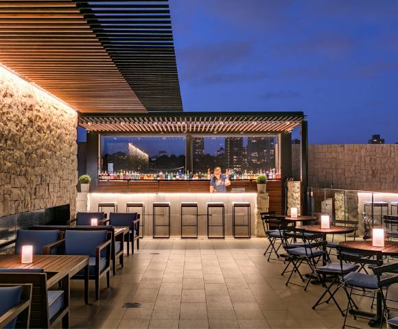 Stylish outdoor seating area with modern furniture and ambient lighting