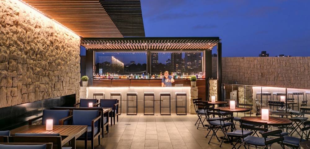 Stylish outdoor seating area with modern furniture and ambient lighting