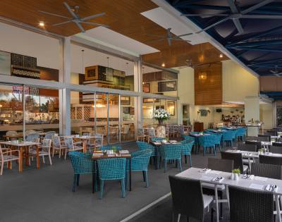 Spacious dining area with neatly arranged tables and chairs in a well-lit, contemporary setting