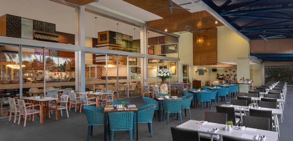 Spacious dining area with neatly arranged tables and chairs in a well-lit, contemporary setting