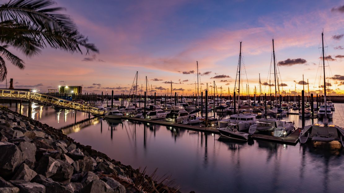 Marina with boats docked at sunset.