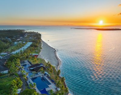 Aerial view of a coastal resort surrounded by turquoise water.