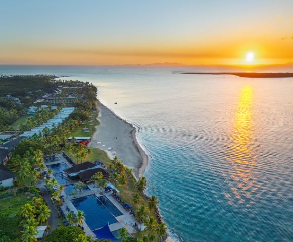 Aerial view of a coastal resort surrounded by turquoise water.