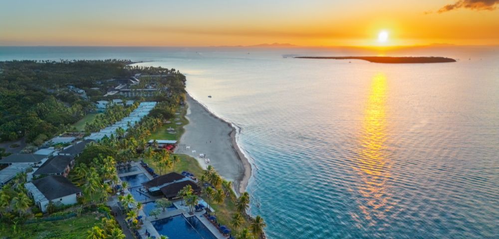 Aerial view of a coastal resort surrounded by turquoise water.
