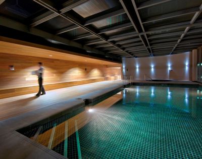 Indoor swimming pool at InterContinental Melbourne The Rialto with sleek modern design and ambient lighting.