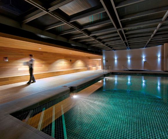 Indoor swimming pool at InterContinental Melbourne The Rialto with sleek modern design and ambient lighting.