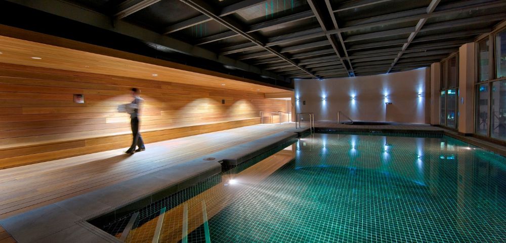 Indoor swimming pool at InterContinental Melbourne The Rialto with sleek modern design and ambient lighting.